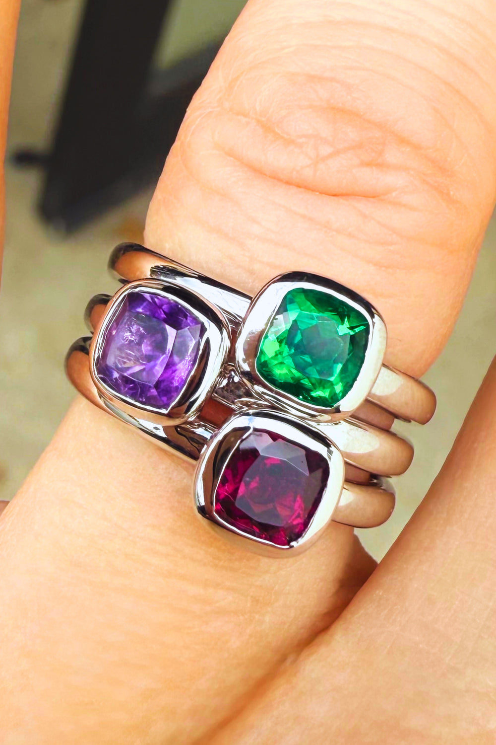 Lab emerald bezel stacking ring — worn on hand