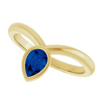 14k yellow gold candlelight ring with sapphire — worn on hand