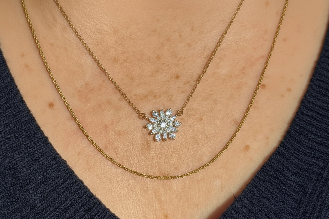 14k yellow gold snowflake diamond pendant necklace — close-up