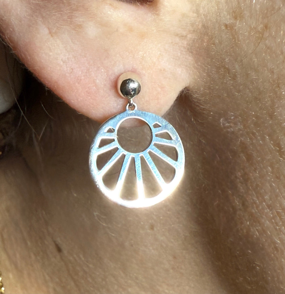 14k yellow gold geometric sun stud earrings — worn on ear
