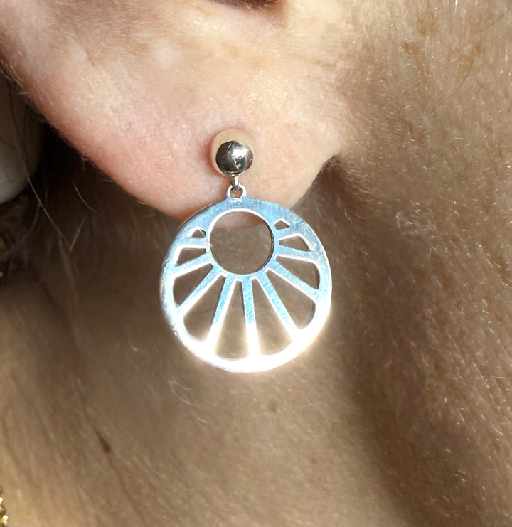 14k yellow gold geometric sun stud earrings — worn on ear