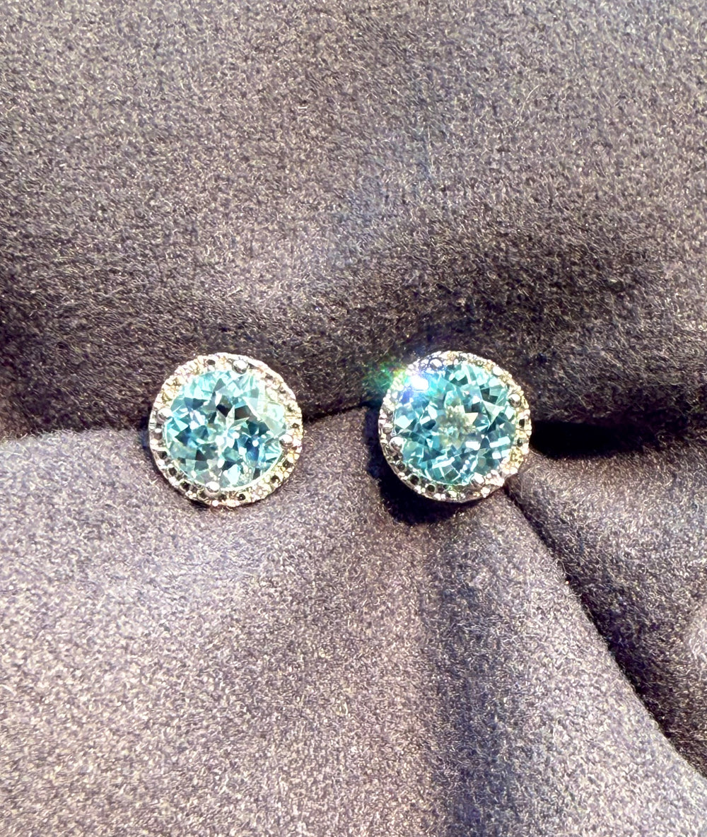 Sterling silver sky blue topaz stud earrings — worn on ear