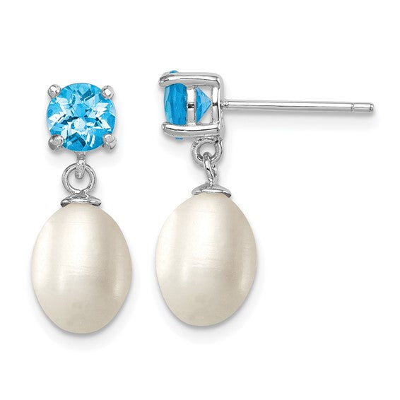 Sterling silver teardrop pearl drop earrings — worn on ear