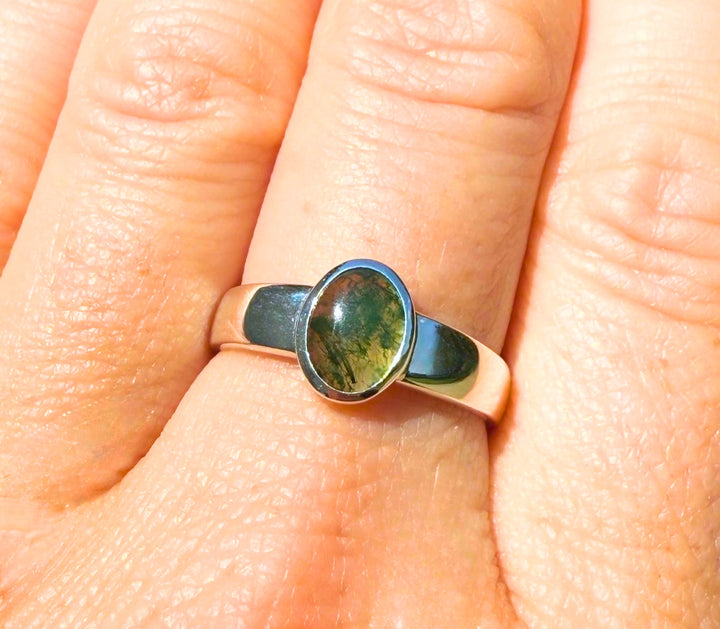 14k yellow gold low-profile moss agate ring — worn on hand