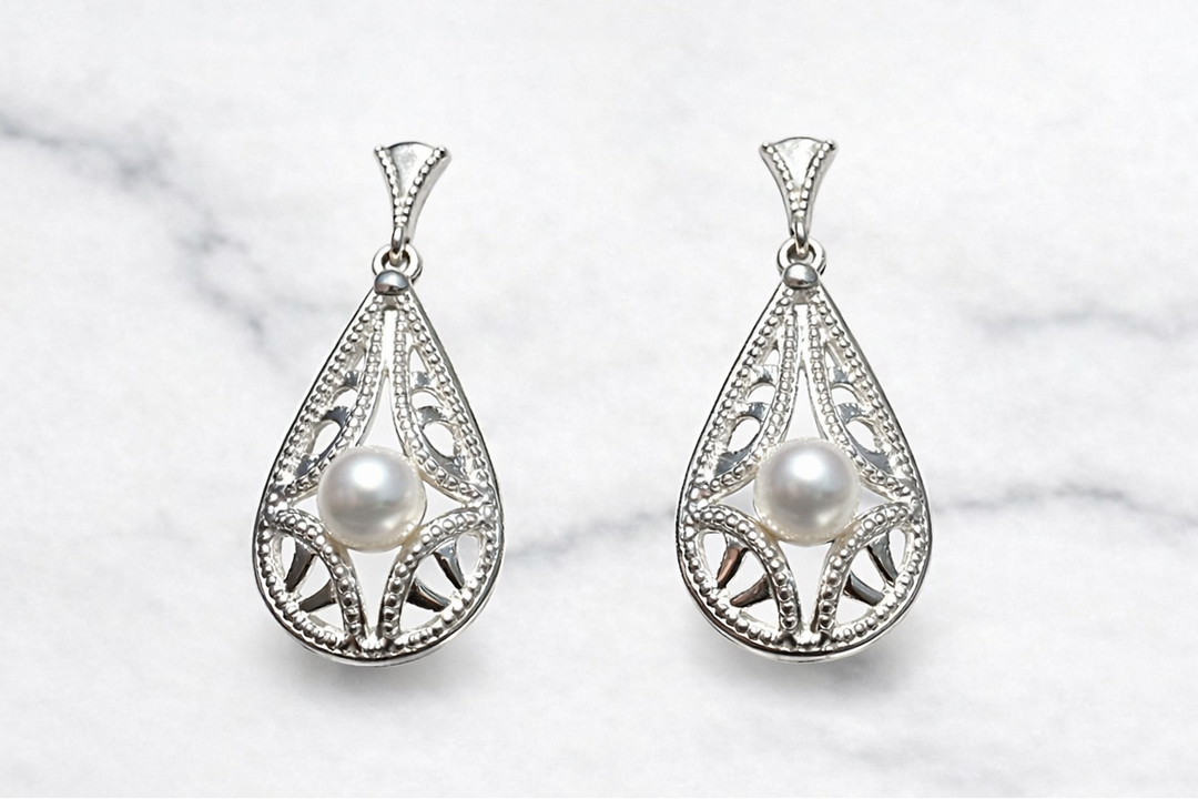 Sterling silver lace pearl drop earrings — worn on ear