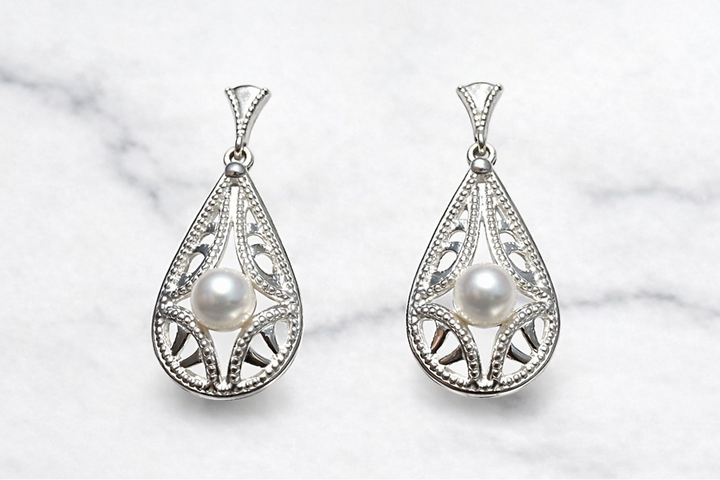 Sterling silver lace pearl drop earrings — worn on ear