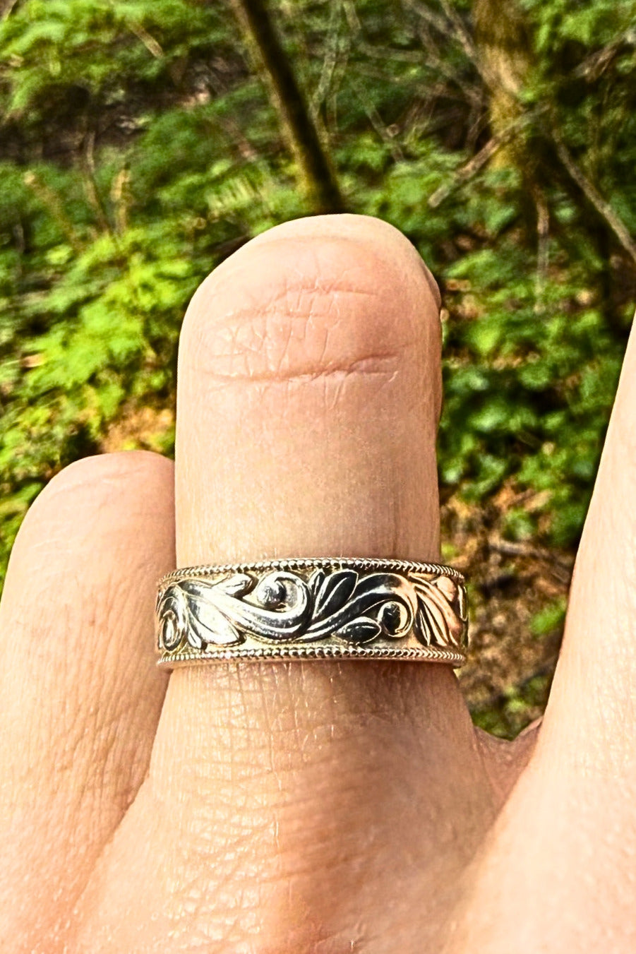 Platinum sculpted engraving wedding band — worn on hand